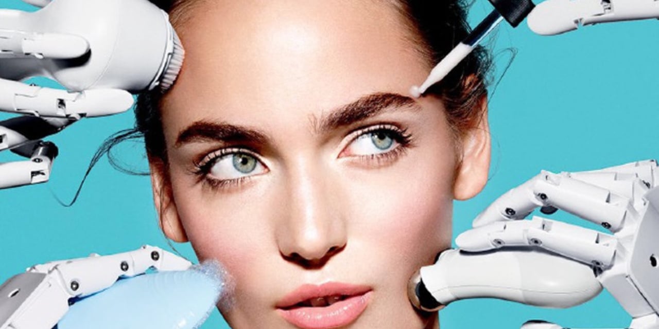 Beauty devices held by robot hands being used on a human face