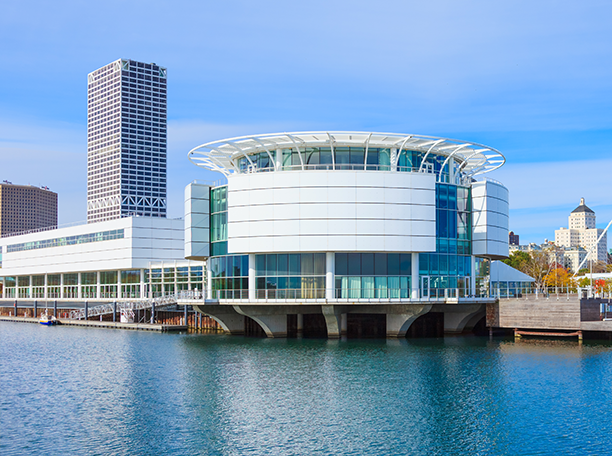 Discovery World’s circular building on Milwaukee’s lakefront with RJF Pro office building rising in the background.